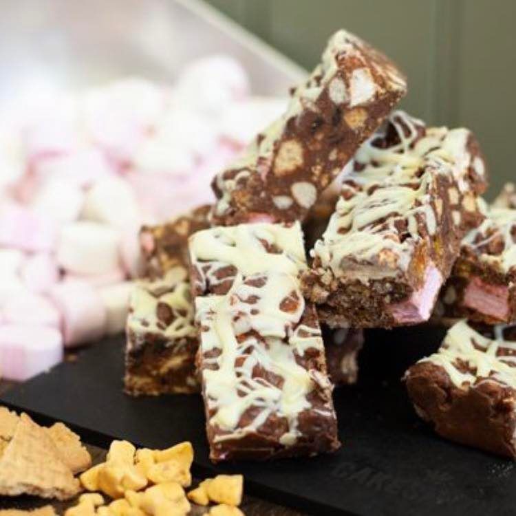 Freshly cut rocky road slices with marshmallow and white chocolate drizzle from the galley